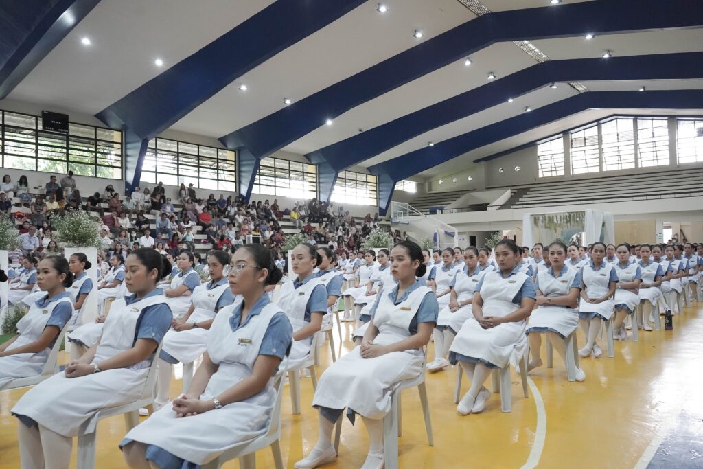 Nursing students sitting down and listening to the speaker during the Capping ceremony